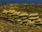20 graugrüne kleine Stoff Sandsäcke, gefüllt, geklebt, 15 x 30 m